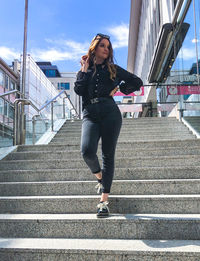 Full length of woman standing on staircase