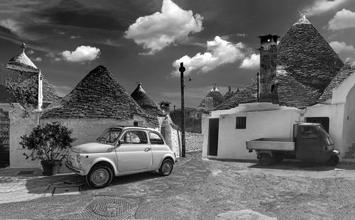 Car on street against buildings in city