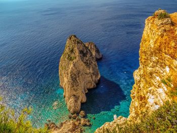 High angle view of rocks at sea shore