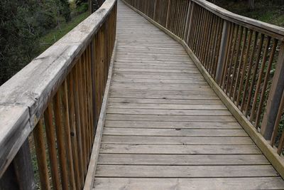 Wooden footbridge over footpath