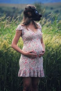 Rear view of woman standing on field