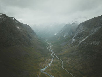 Scenic view of road through valley against sky