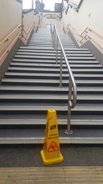 High angle view of yellow text on staircase