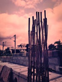 Close-up of wooden fence against sky during sunset