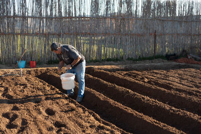 Side view of man working at farm