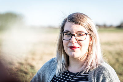 Portrait of a woman wearing sunglasses on field