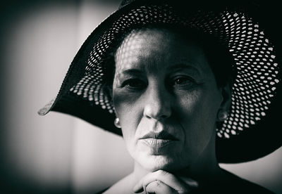 Close-up of thoughtful woman wearing hat
