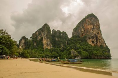 Scenic view of sea and mountains against sky