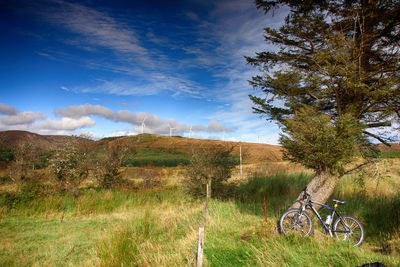 Bicycle on field against sky