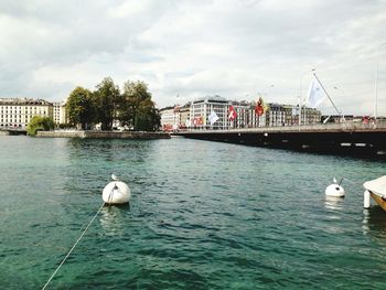 Bridge over river against cloudy sky