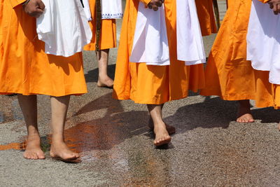 Low section of people standing on street