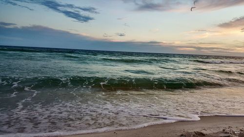 Scenic view of beach against sky during sunset