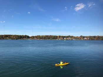 Man on boat in river against sky