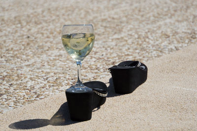 Close-up of drink on sand