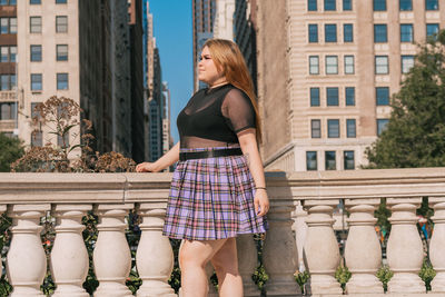 Full length of woman standing against building