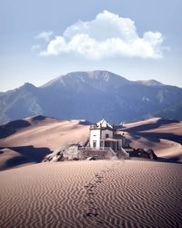 Scenic view of desert against cloudy sky