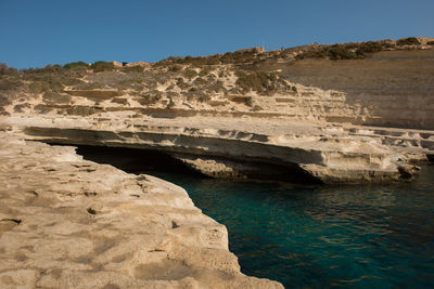 Saint peter's pool. rocky beach in malta