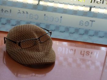 Eyeglasses with flat cap on table