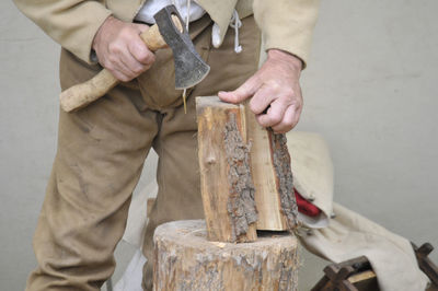 Midsection of man working on wood