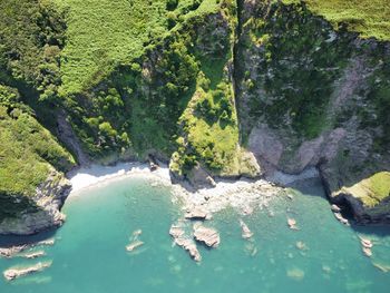 High angle view of sea amidst rocks