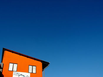 Low angle view of roof against clear blue sky