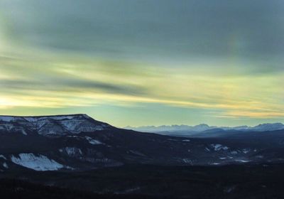 Scenic view of mountains against cloudy sky