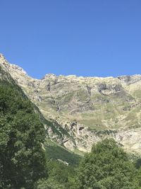 Scenic view of mountains against clear blue sky