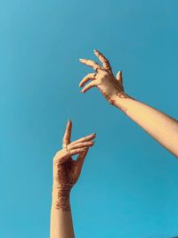 Close-up of hand against clear blue sky