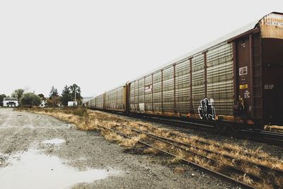 Train on railroad track against clear sky