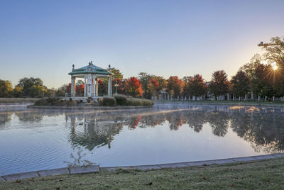 Built structure by lake against clear sky