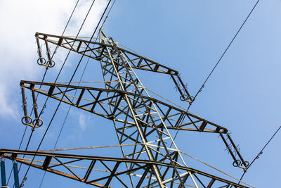 Low angle view of electricity pylon against clear sky