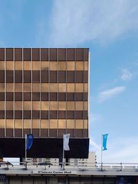 Low angle view of modern building against blue sky