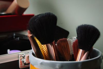 Close-up of make-up brushes in container