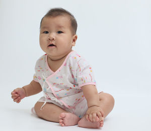 Portrait of cute baby against white background