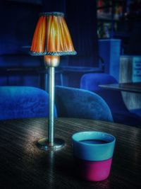 Close-up of illuminated lamp on table