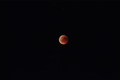 Low angle view of moon against sky at night