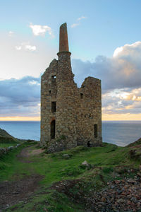 Historic building by sea against sky