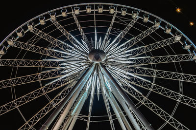 Low angle view of ferris wheel at night