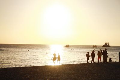 People on beach at sunset