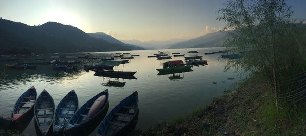 Boats in lake at sunset