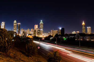 Light trails on road in city at night