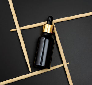 Brown glass bottle pipette on a black background. pharmacy concept. collagen skin. mockup skincare 