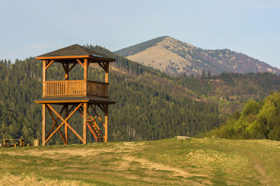 Built structure on field against sky