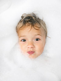 Portrait of cute baby in bathtub