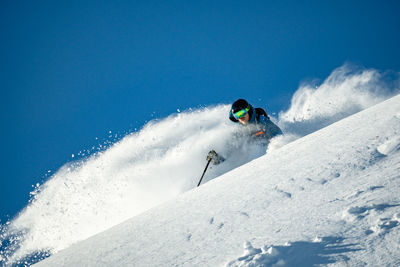 Man skiing in deep powder snow, gastein, salzburg, austria