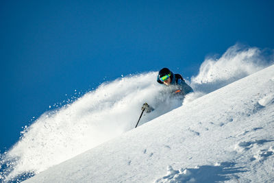 Man skiing on snow covered landscape