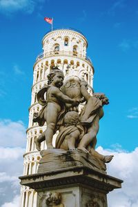 Low angle view of statue of historical building against cloudy sky