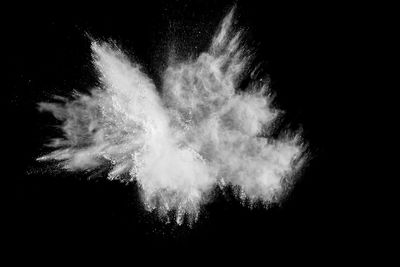 Defocused image of powder paints against black background