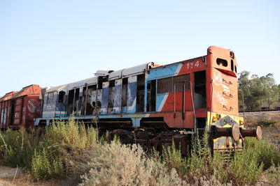 Train on railroad track against clear sky