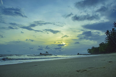 Scenic view of beach against sky during sunset